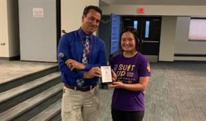 Principal and student with award