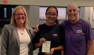 Principal, student with award and teacher