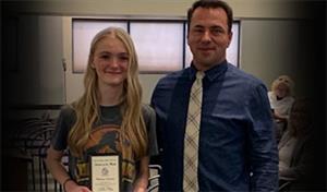 Student with award and principal